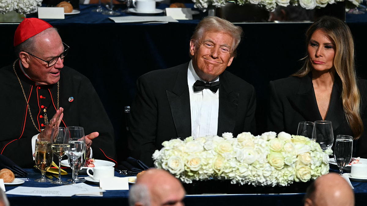 Former US President and Republican presidential candidate Donald Trump with his wife Melania Trump and Archbishop of New York Timothy M. Dolan (L) attend the 79th Annual Alfred E. Smith Memorial Foundation Dinner at the Hilton Midtown in New York, October 17, 2024. (Photo by Timothy A. CLARY / AFP) (Photo by TIMOTHY A. CLARY/AFP via Getty Images)