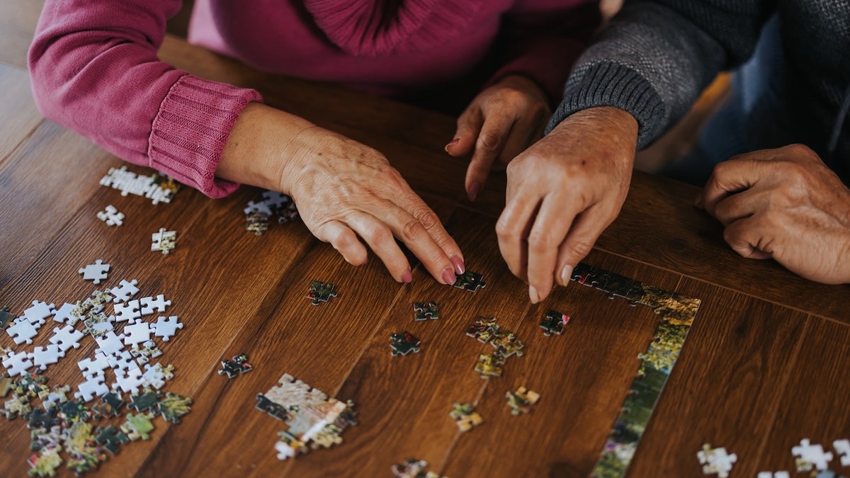 Older people doing puzzle