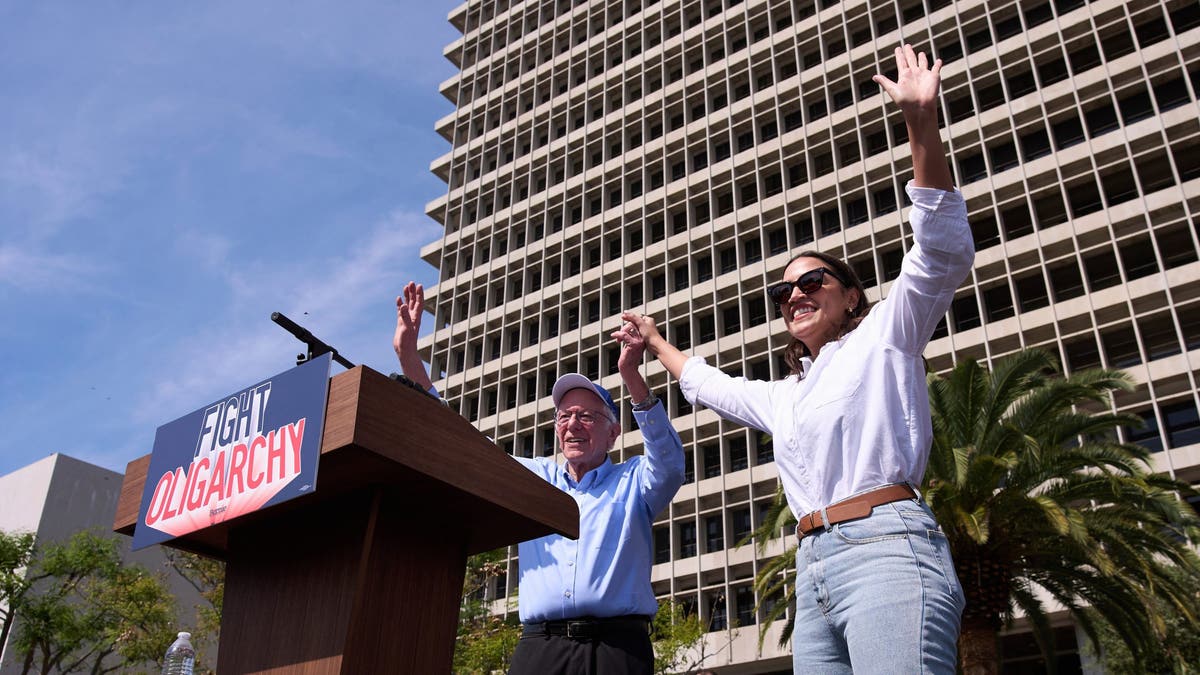 Sanders and AOC waving to the crowd