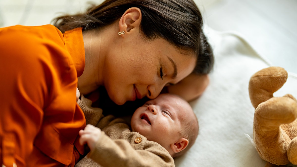 mother and baby napping at home
