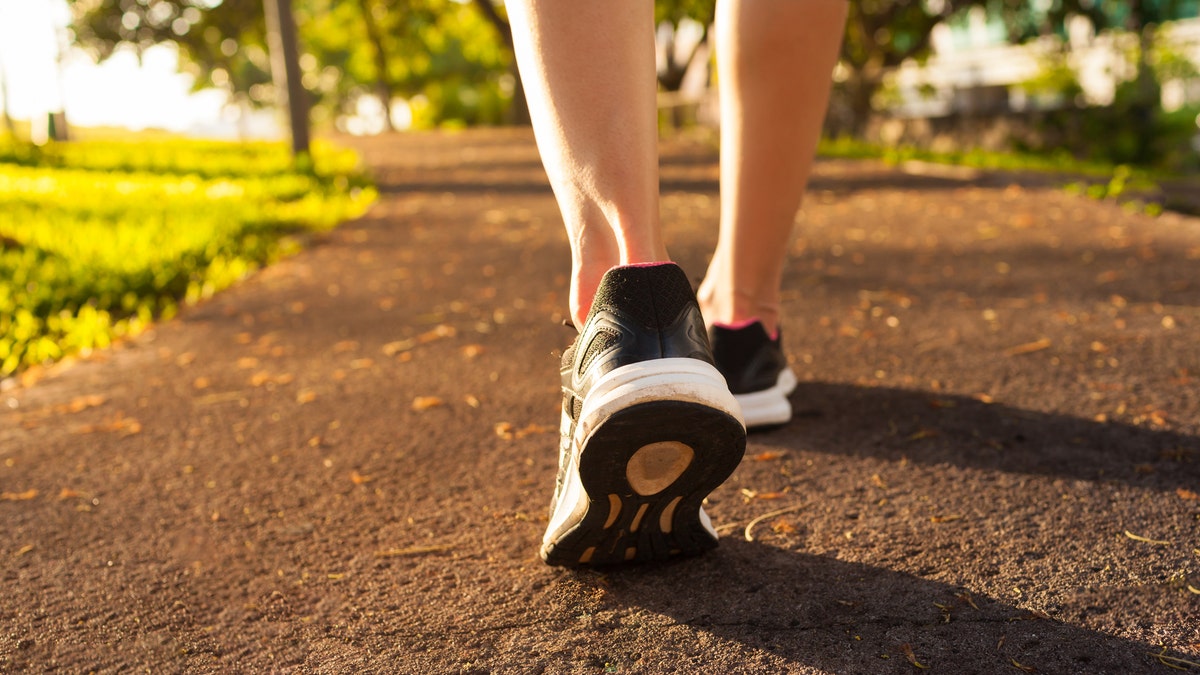 Close up woman walking on a path. Fitness concept.