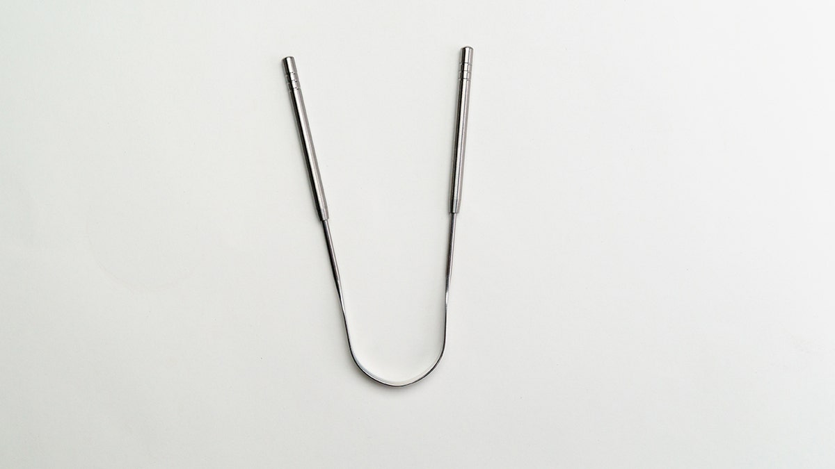 A metal tongue scraper