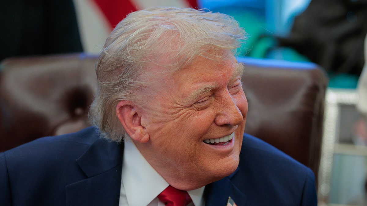 U.S. President Donald Trump smiles as he speaks to the media