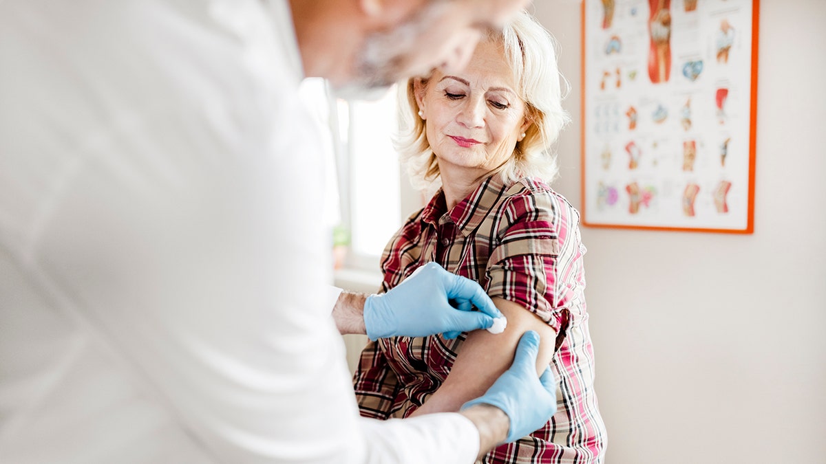 senior woman receives vaccine