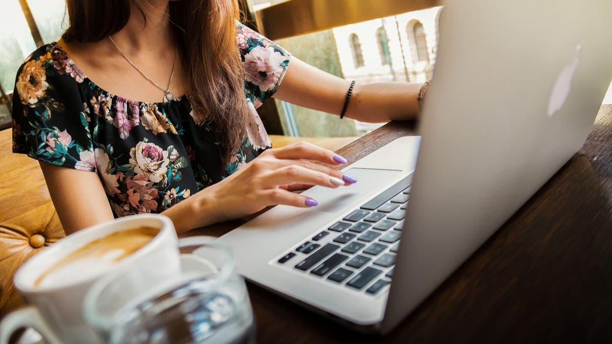 A woman using ChatGPT on her laptop