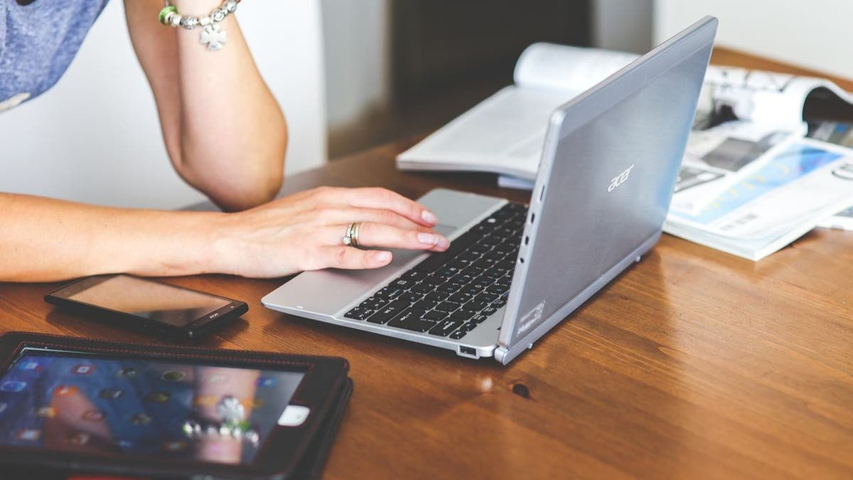 woman typing on laptop