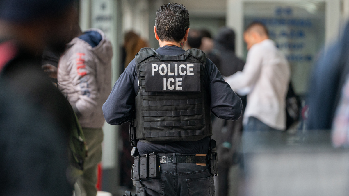 ICE agent seen from behind in New York City