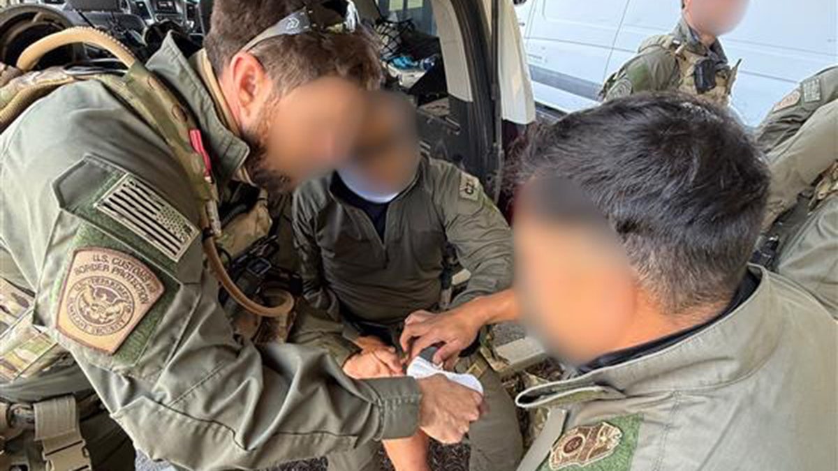 A Border Patrol agent receives medical attention after being injured by a flying rock.