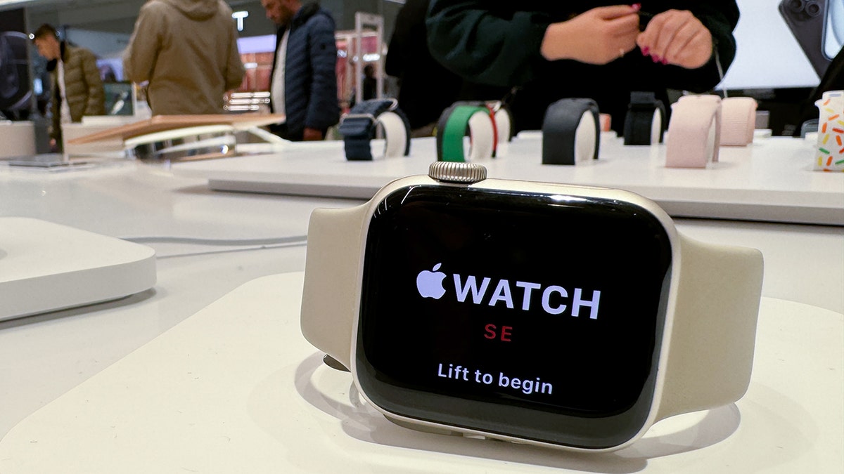 Apple watch on a table with people shopping in the background