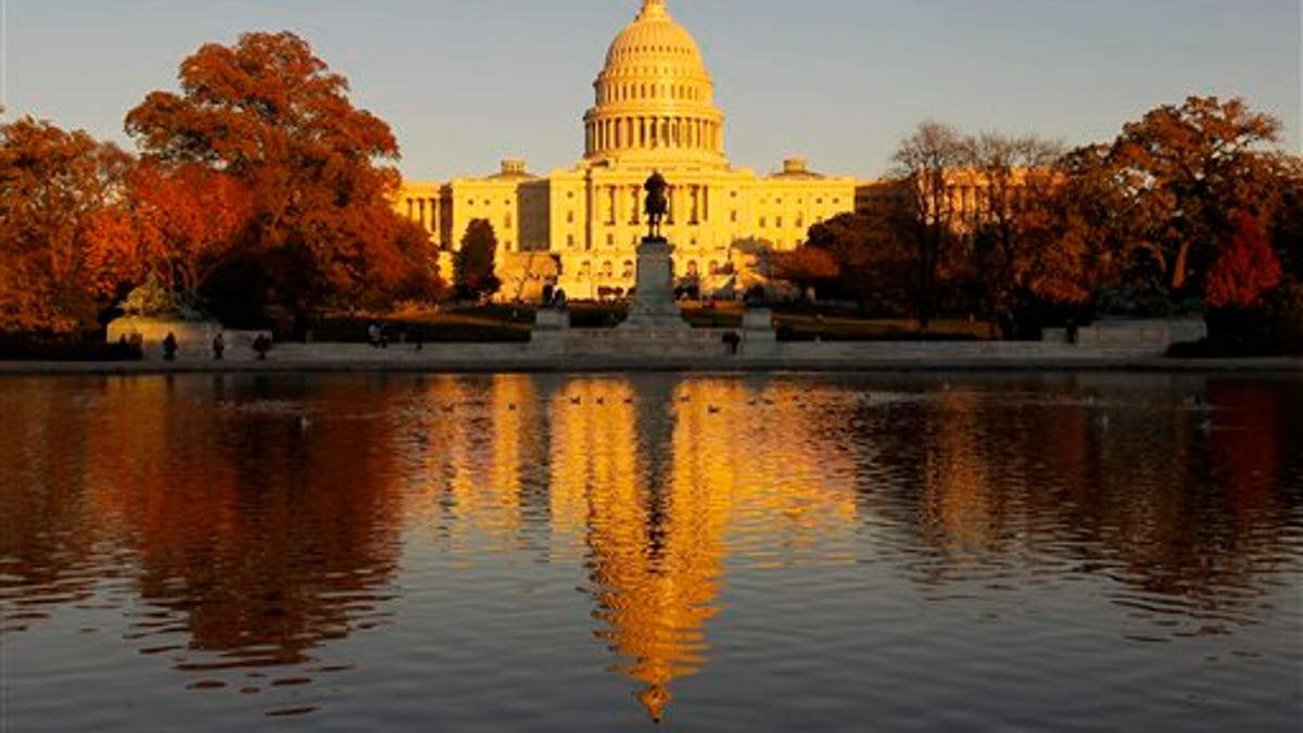 The US Capitol is bathed in the setting sun and seen in the reflecting pool on Capitol Hill in Washington, Friday, Nov. 12, 2010. Congress returns next week for a post-election lame duck session. (AP Photo/Alex Brandon)