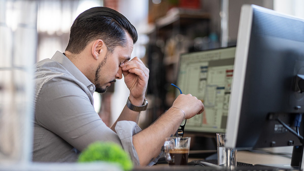 stressed out man working at computer