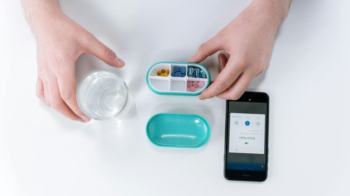 A woman using a health app to keep track of pills