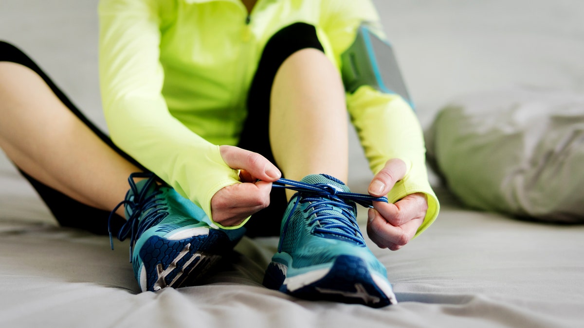 Woman tying sneakers
