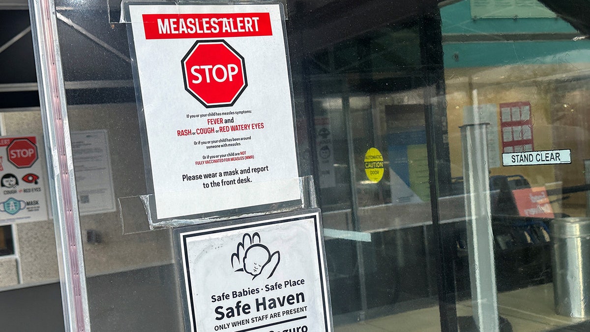 Measles alert sign on a door