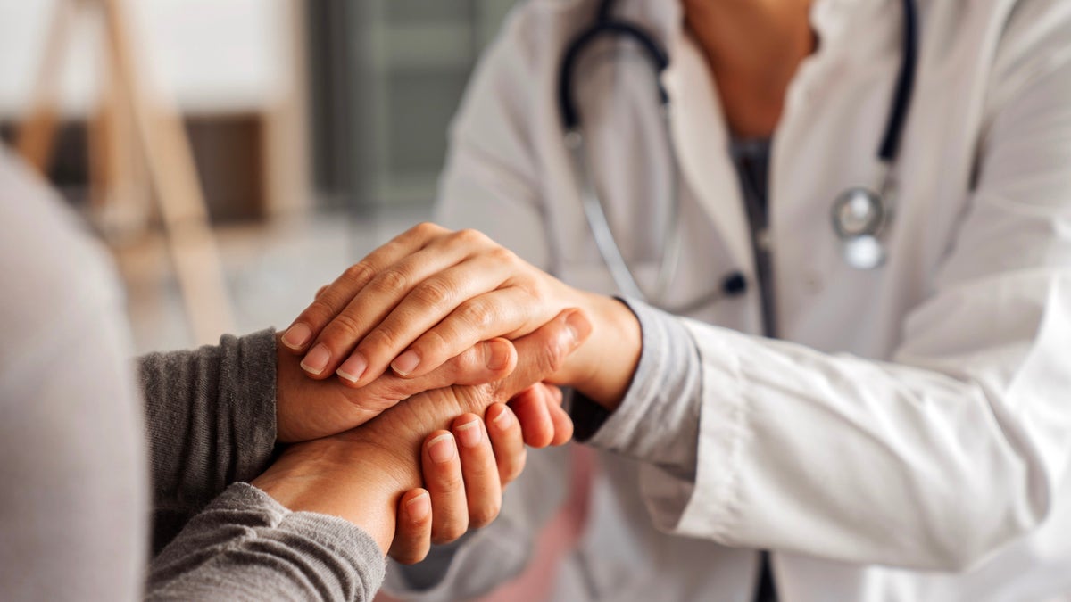 Doctor comforting patient