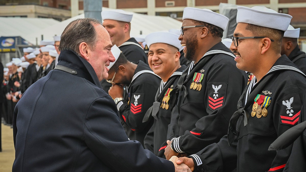 Secretary Phelan shakes hands with Navy sailors