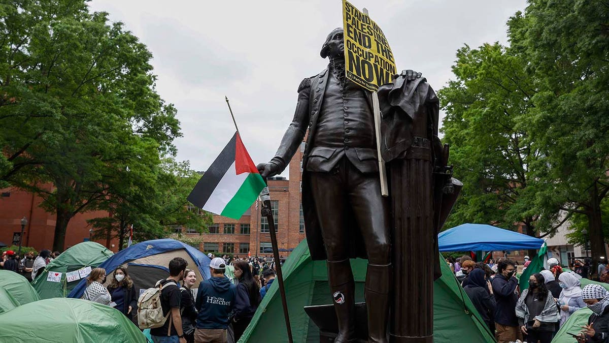 George Washington statue holding a Palestinian flag on the GWU campus