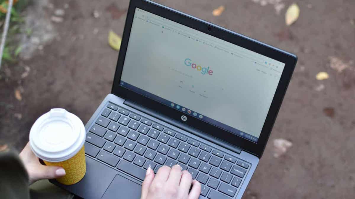 A person types on their laptop.