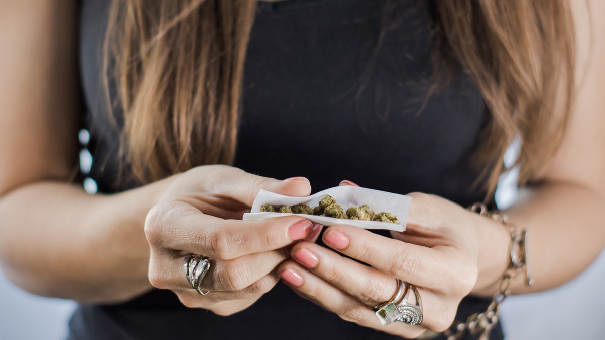 A marijuana joint being hand rolled close up