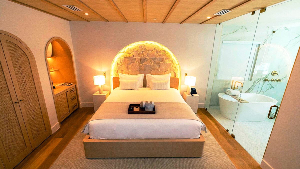 Hotel room with the lights on.