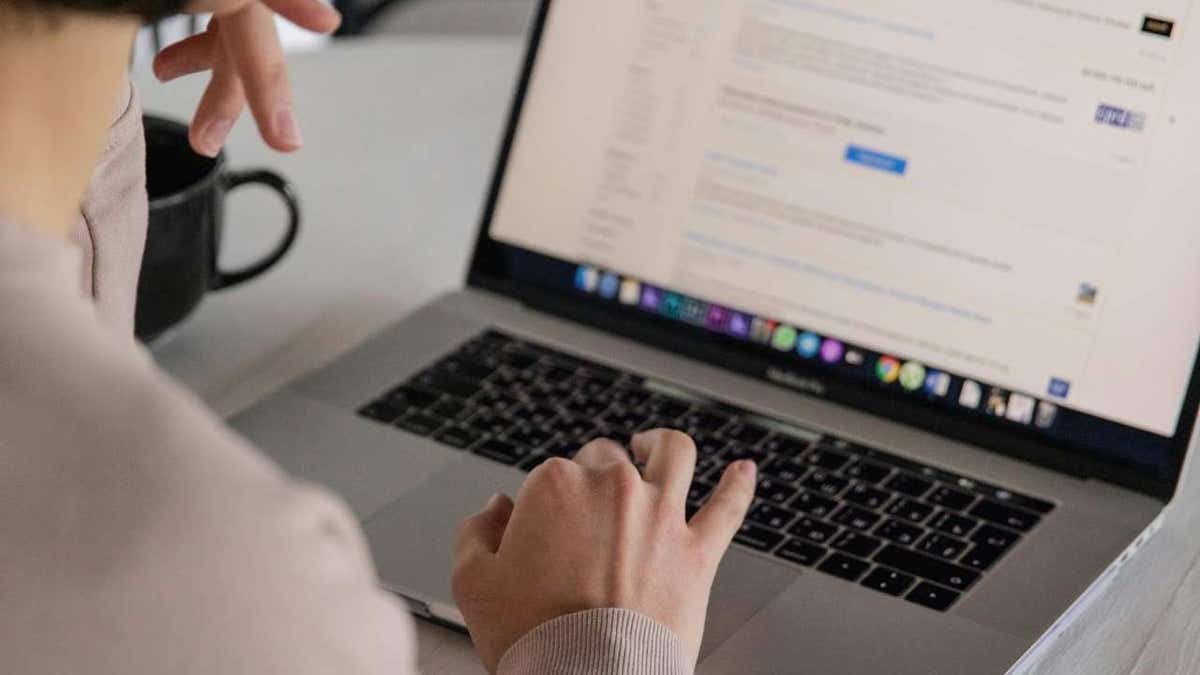 Person reviewing email inbox on laptop