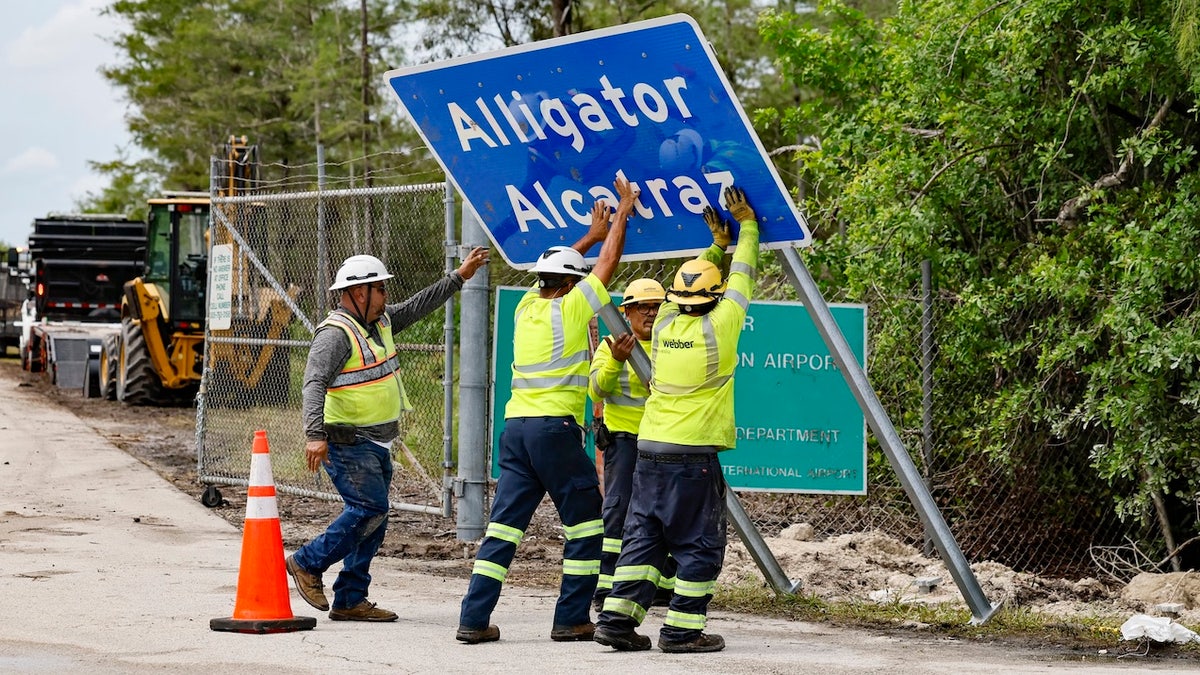 Workers install a permanent Alligator Alcatraz sign. The facility is within the Florida Everglades, 36 miles west of the central business district of Miami, in Collier County. Florida, on Thursday, July 3, 2025. (Photo via Getty Images)