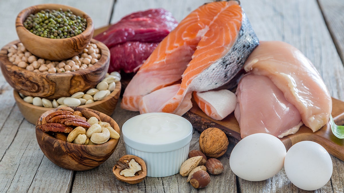 Selection of protein-rich foods like eggs, salmon, chicken, and nuts.