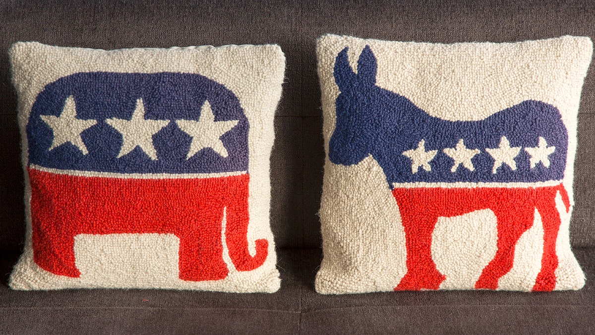 Pillow with Republican elephant symbol next to a pillow with the Democratic donkey symbol