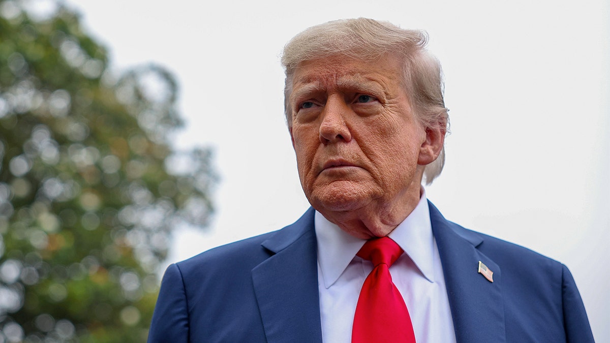 U.S. President Donald Trump stops and talks to the media