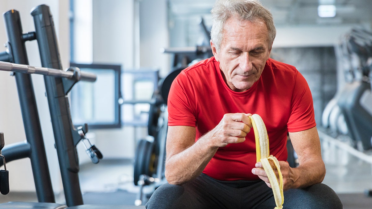 senior man eating a banana
