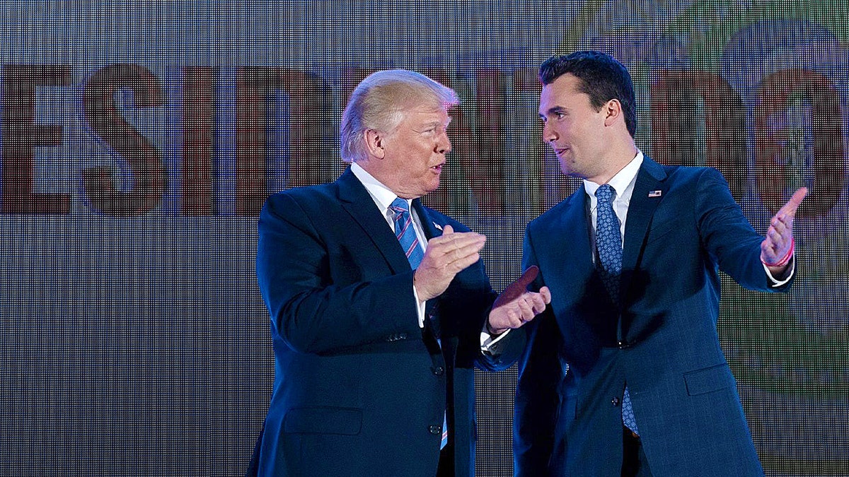 charlie kirk and donald trump durign rally smiling