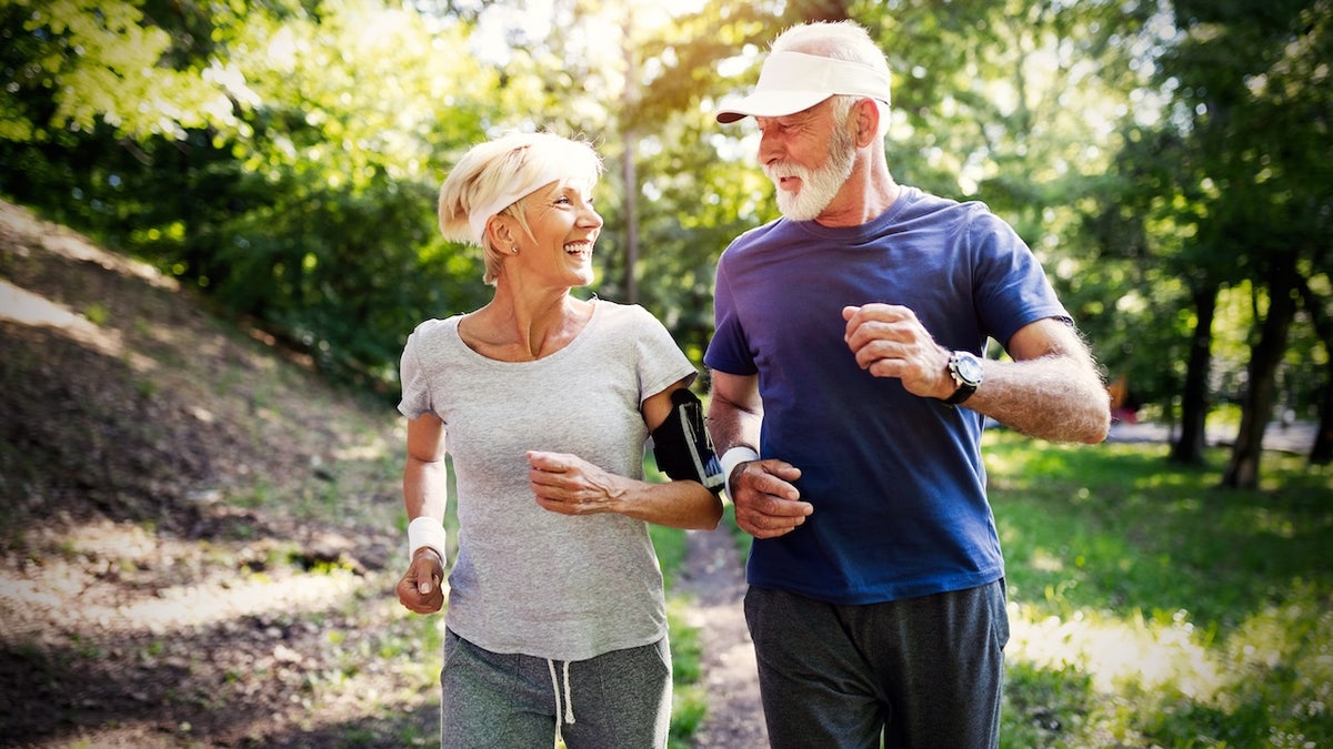 Older couple jogging outside