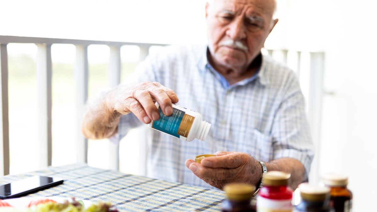 Elderly man taking vitamin K