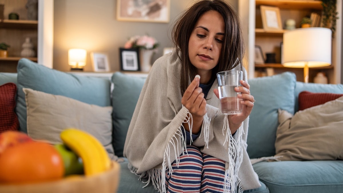 Woman taking antibiotic pill