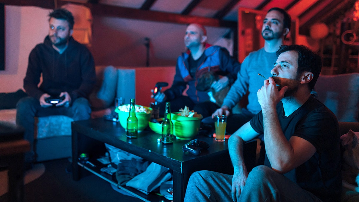 friends play video games and smoke a joint