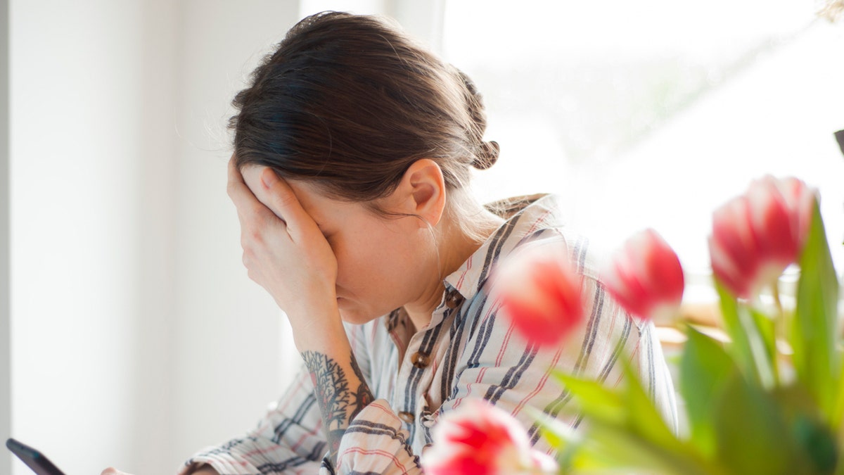 A woman scrolling on social media