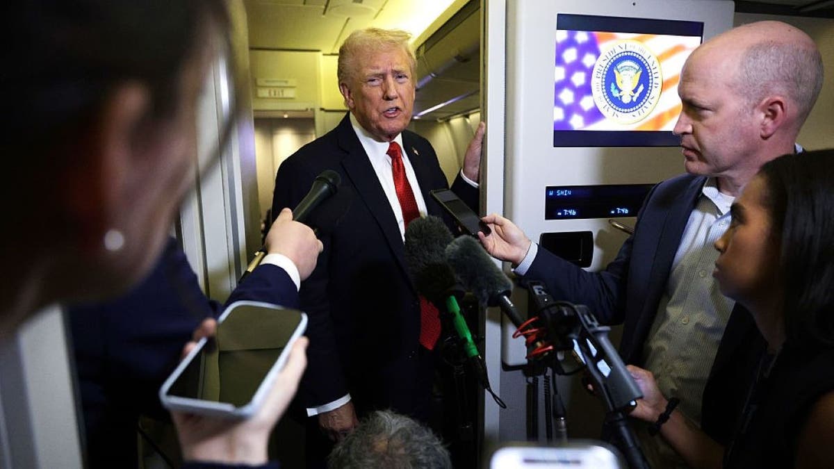 Donald Trump answers questions aboard Air Force One