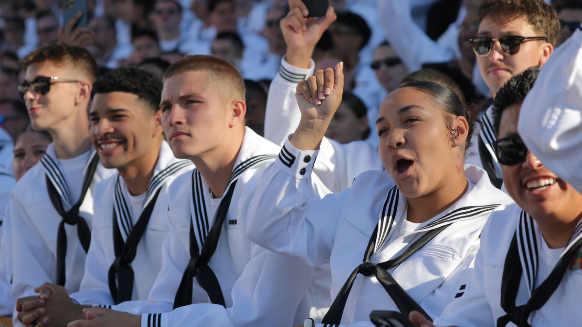 Naval cadets listen to President Donald Trump's speech aboard the USS Harry S. Truman aircraft carrier
