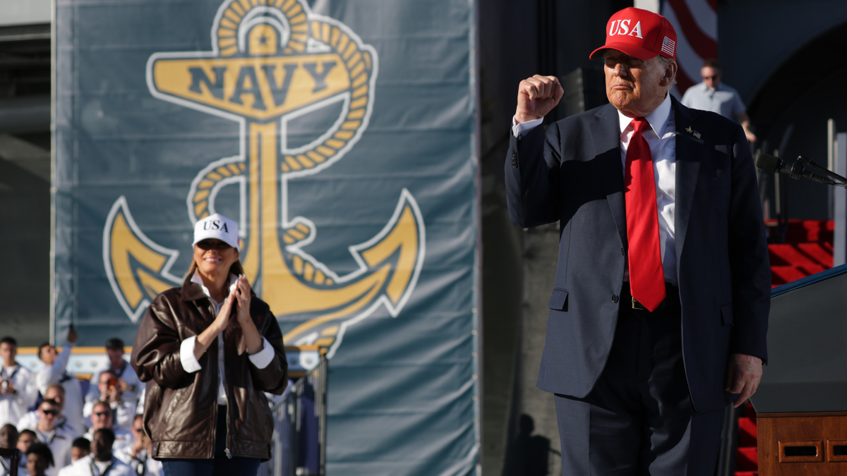 First Lady Melania Trump claps as U.S. President Donald Trump raises his fist after making remarks during the Navy 250 Celebration at the USS Harry S. Truman aircraft carrier