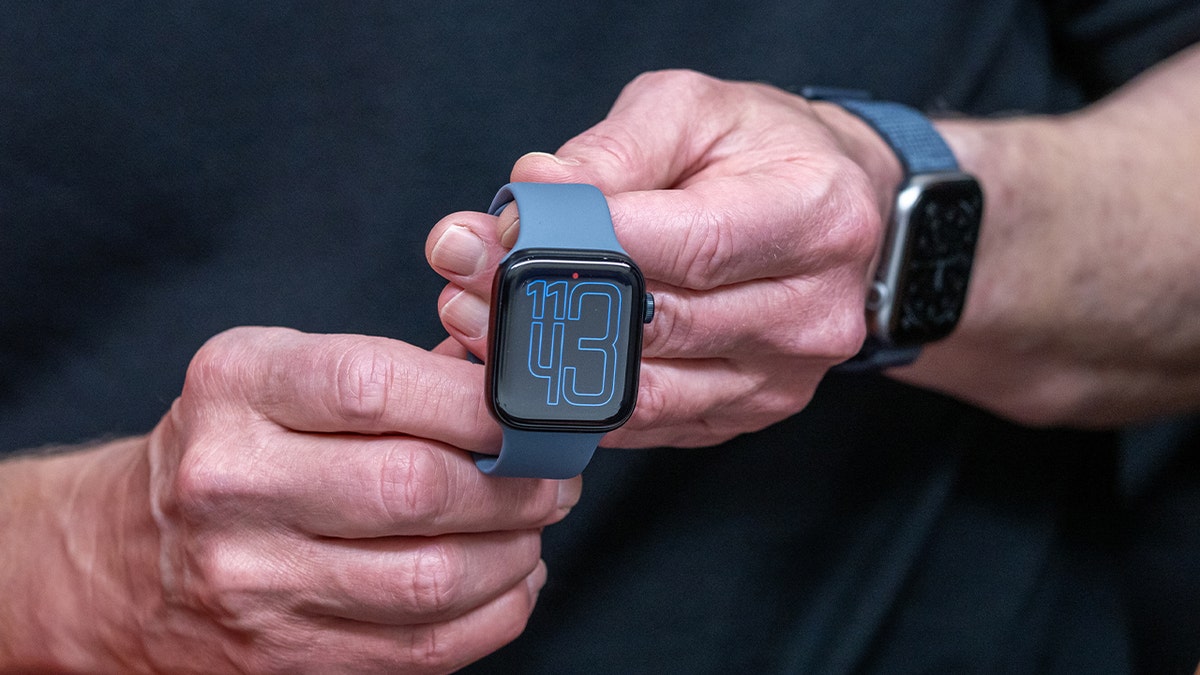 hands holding apple watch