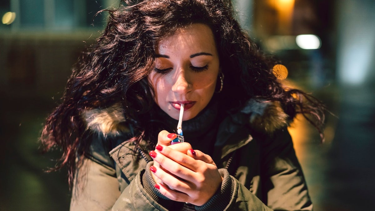 Young woman smoking cigarette