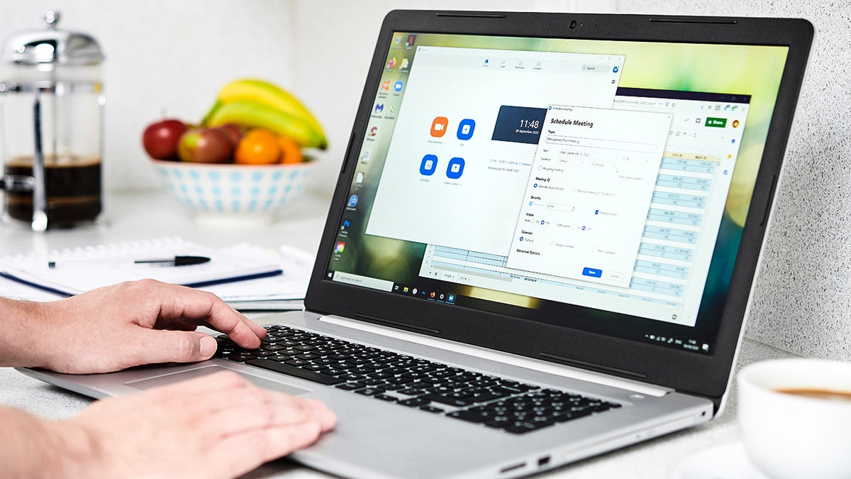 Man typing on his laptop.