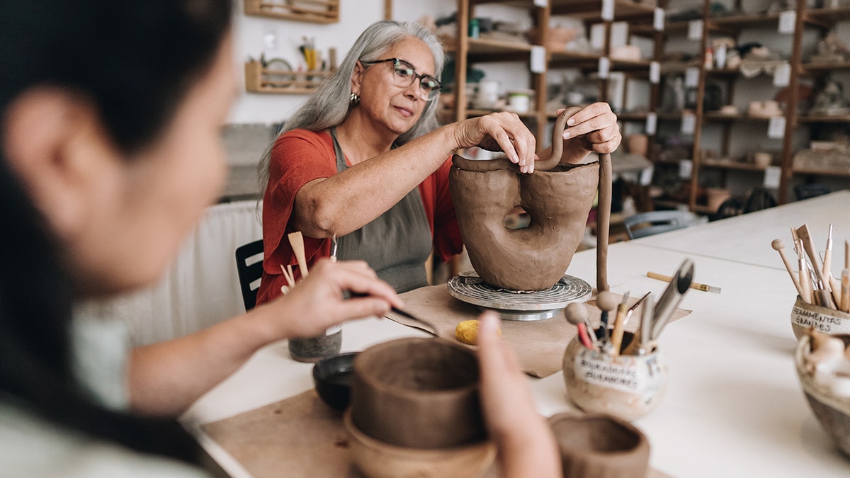 Women working on ceramics project in a class.