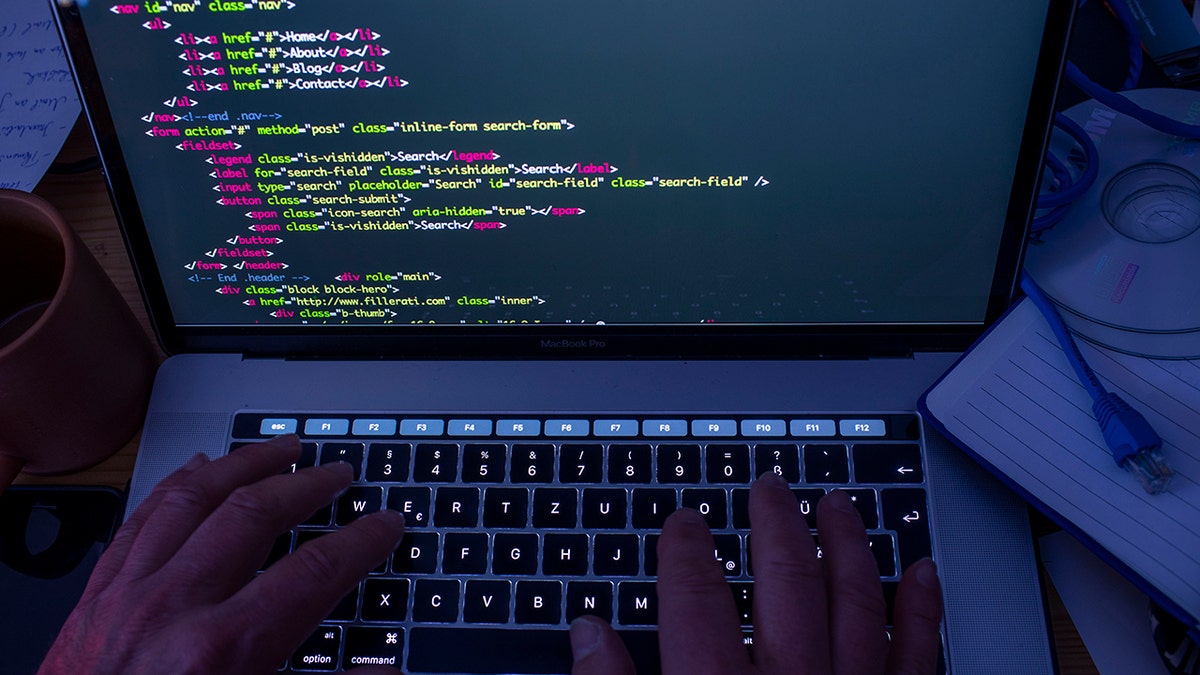 Someone typing code on a computer.