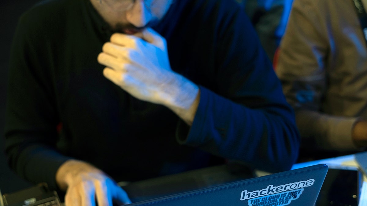 Hacker typing on a computer.