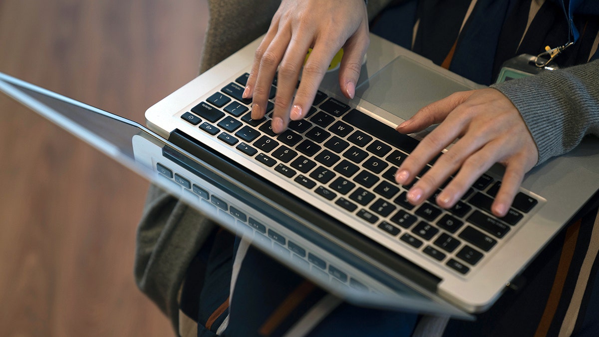 Woman typing on her laptop.