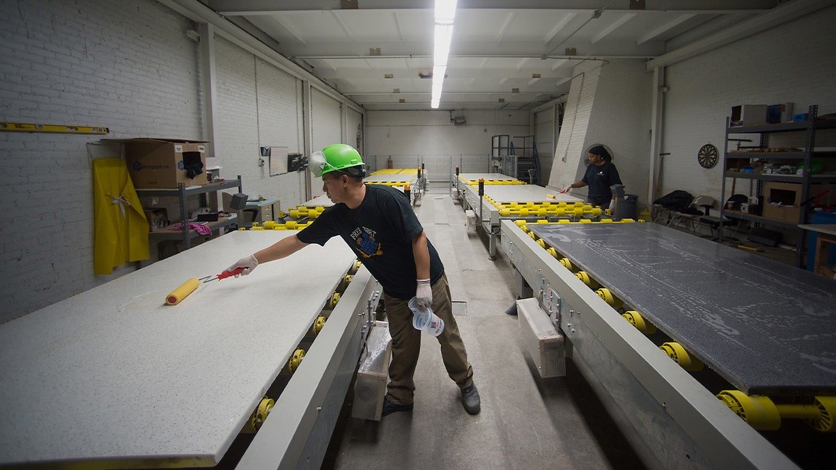 workers manufacturing white countertops