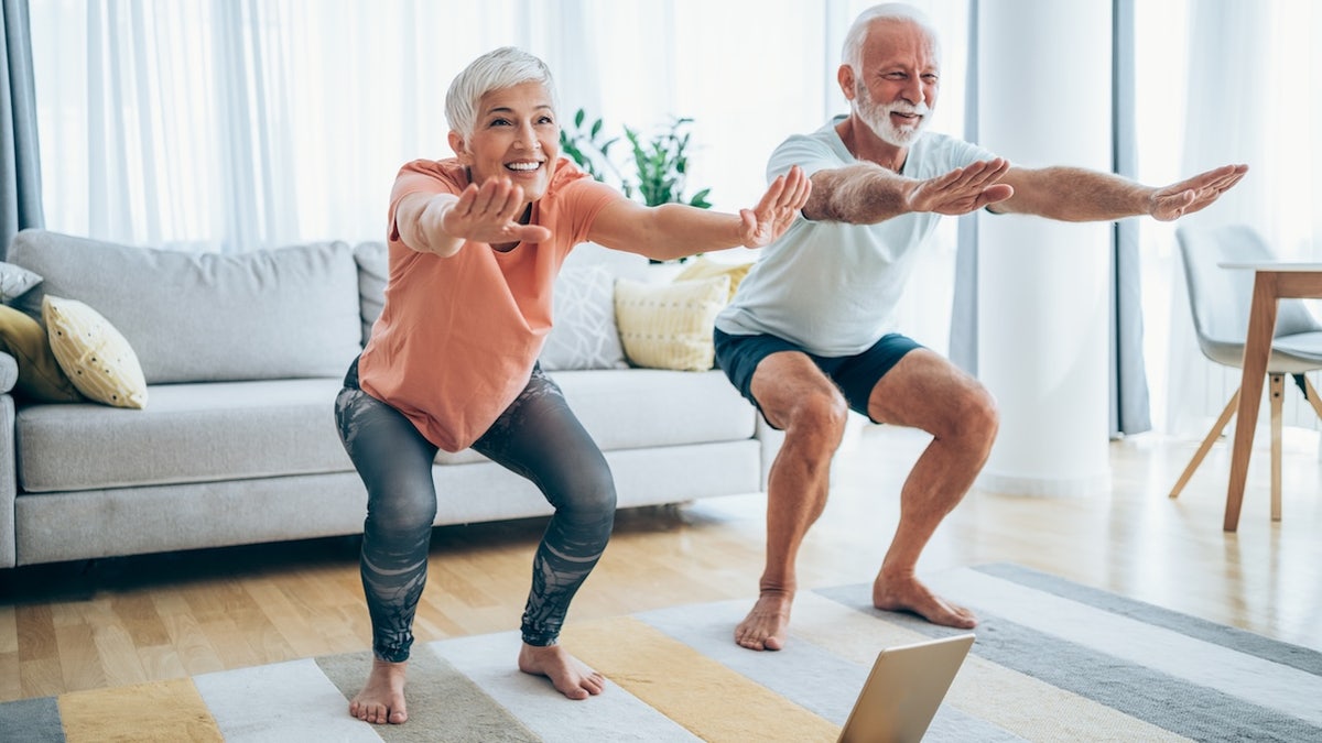 Older couple doing squats
