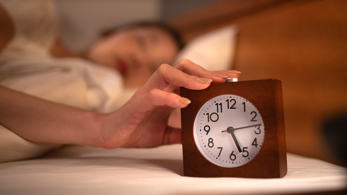 Woman waking up alarm clock