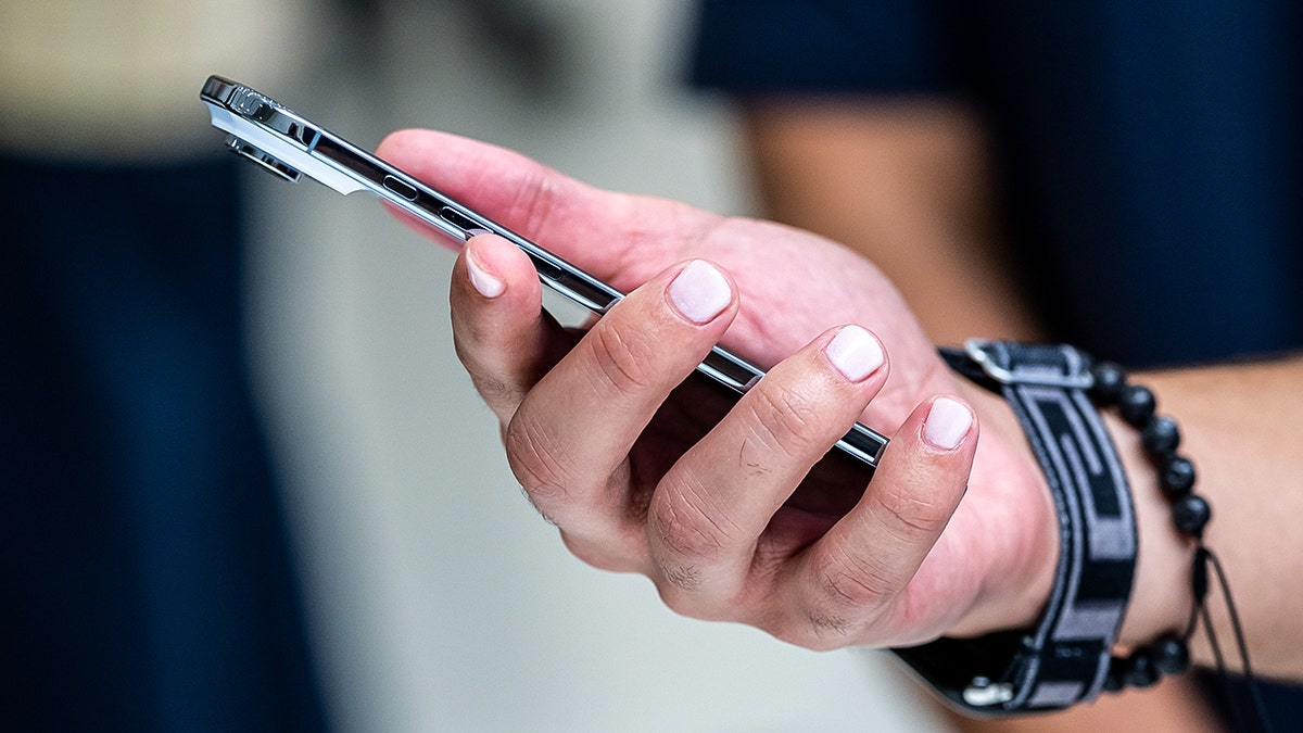 Woman holding her smartphone.